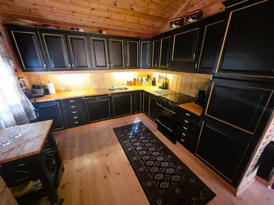 an overhead view of a kitchen with black cabinets at Cozy Cabin Retreat in Trysil, Norway for Families in Trysil
