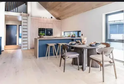 a kitchen with a wooden ceiling and a table and chairs at New house in the center of Trysil in Trysil