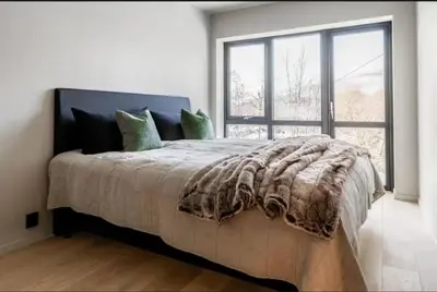 a bedroom with a large bed with a large window at New house in the center of Trysil in Trysil