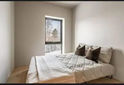 a bedroom with a large bed with a window at New house in the center of Trysil 2 in Trysil