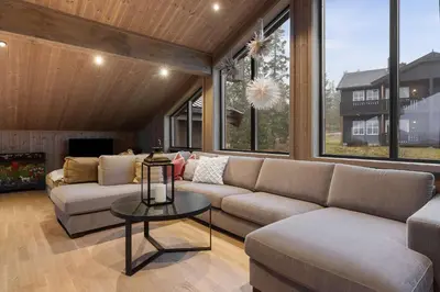 a living room with a couch and a table at Mountain Chalet 958 by Vacation Trysil in Trysil