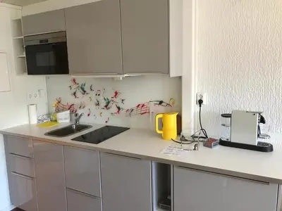 a kitchen with a sink and a counter top at Solstrand Fjord Holiday in Eidsvåg