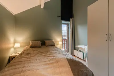 a large bed in a room with a window at Alpine Apartment with Parking and Balcony in Ustaoset