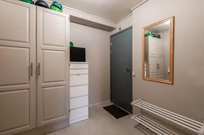 a walk in closet with white cabinets and a mirror at Alpine Apartment with Parking and Balcony in Ustaoset