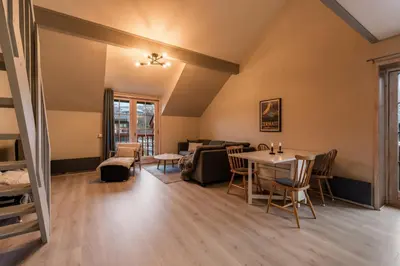 a living room with a table and chairs at Alpine Apartment with Parking and Balcony in Ustaoset