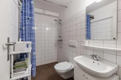 a white bathroom with a toilet and a sink at Alpine Apartment with Parking and Balcony in Ustaoset
