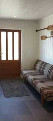 a room with three benches in a room with a door at Renovated Chapel With Fjord Views In Vågstranda in Reistad