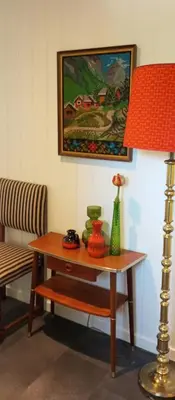 a living room with a table with a lamp and a painting at Renovated Chapel With Fjord Views In Vågstranda in Reistad
