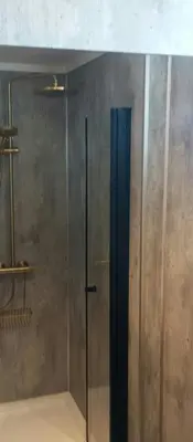 a shower with a glass door in a bathroom at Renovated Chapel With Fjord Views In Vågstranda in Reistad