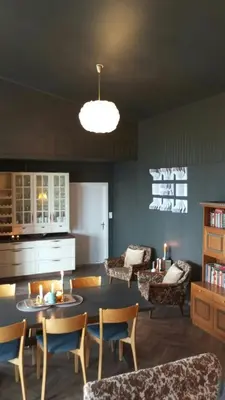 a living room with a table and chairs at Renovated Chapel With Fjord Views In Vågstranda in Reistad