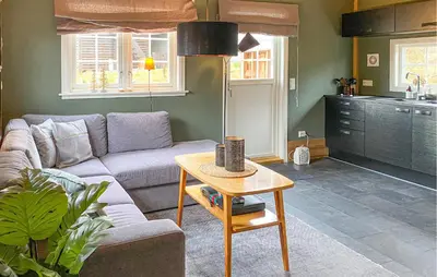 a living room with a couch and a table at 2 Bedroom Cozy Home In Straumgjerde in Brunstad