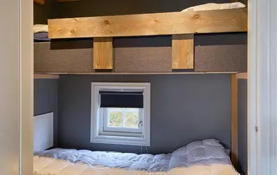 a bunk bed in a room with a window at 2 Bedroom Cozy Home In Straumgjerde in Brunstad