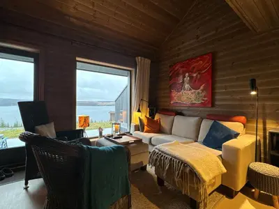 a living room with a couch and a table at Moderne leilighet på Glomsrud Golsfjellet vest in Gol