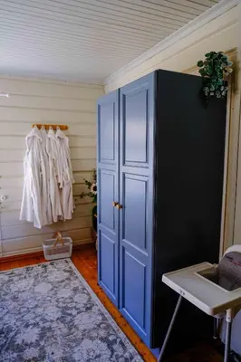 a room with a blue door and a closet at Leave It All in Venabygd