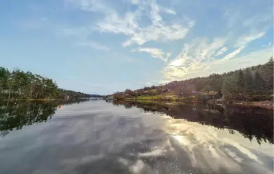 a view of a river with trees and clouds in the water at Cozy Home In Førde I Hordaland in Erve