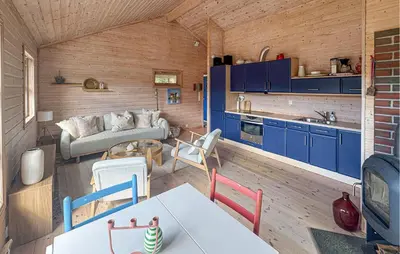 a kitchen and a living room with blue cabinets at 1 Bedroom Cozy Home In Førde I Hordaland in Erve