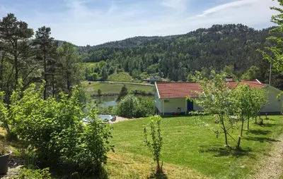 a house in the middle of a field with trees at 1 Bedroom Cozy Home In Førde I Hordaland in Erve
