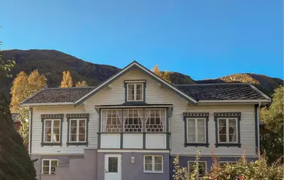 a house with a mountain in the background at Beautiful Home In Vistdal With Wifi in Myklebostad