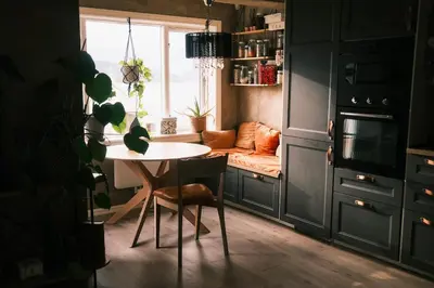 a kitchen with a table and a couch in a room at Cozy house in historical area in Bergen