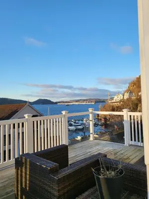 a balcony with a view of the water at Cozy house in historical area in Bergen