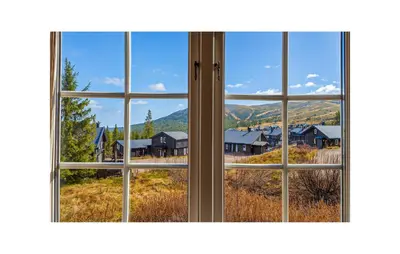 a window with a view of a village through it at Awesome Apartment In Trysil With Sauna in Trysil