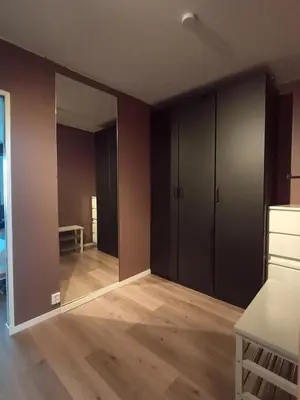 an empty room with brown walls and wooden floors at Cozy Studio in Hallset, Trondheim in Trondheim