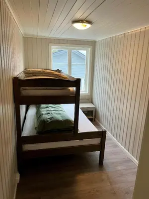 a bunk bed in a room with a window at Grey Lodge in Isfjorden