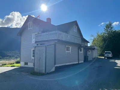 a house with a car parked in front of it at Grey Lodge in Isfjorden