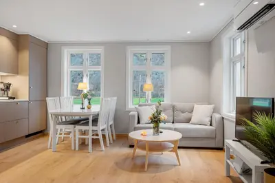 a living room with a couch and a table at Jordeplegarden Apartments in Tønjum