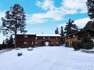 a large building with snow on the ground at Mountain Lodge - Midtgardstunet in Ringebu