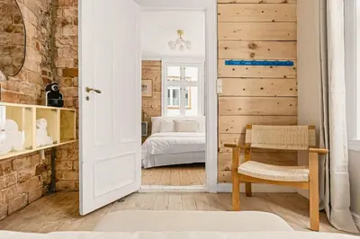 a room with a bedroom with a bed at The 1880 Authentic Bergen Dream I 500m to Bryggen in Bergen