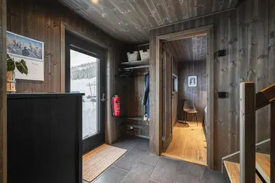 a room with a hallway with a door and a window at Hemsedal ski in ski out, modern comfort by the slopes in Hemsedal