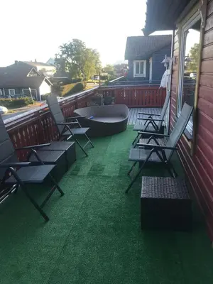 a patio with chairs and a tub on a house at Townhouse with 4 bedrooms near Sørstrand