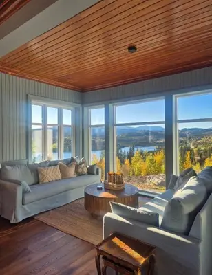 a living room with a couch and a table and windows at Rent your own Boutiqe hotel in Skammestein