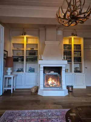 a living room with a fireplace and a chandelier at Rent your own Boutiqe hotel in Skammestein