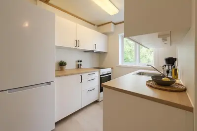a white kitchen with white cabinets and a sink at Twin Flat 2nd Floor Bergen Centre - Norwegians minimum age 25 in Bergen