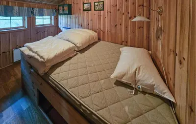 a bedroom with two beds in a wooden room at 4 Bedroom Gorgeous Home In Rjukan in Rjukan