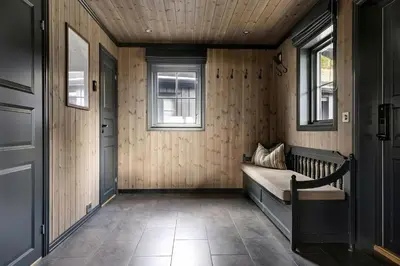 a hallway with a bed in a room with two windows at Bo På Norefjell Rett Ved Alpint Og Langrenn in Noresund
