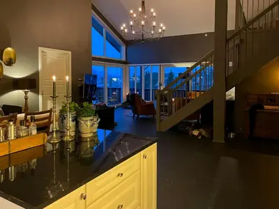 a kitchen with a counter top and a living room at Panoramic Apartment In The Heart Of Beitostølen in Beitostøl