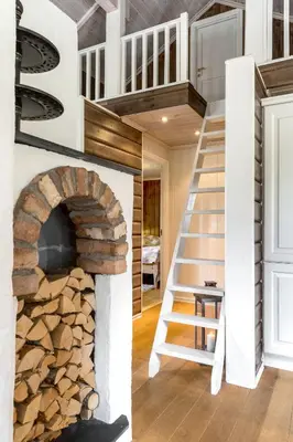 a house with a spiral staircase and a fireplace at Fjellkos, mountain cabin in Gol in Gol