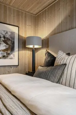 a bedroom with a white bed and a lamp at Trysilfjell hytteområde 2115 by Vacation Trysil in Trysil
