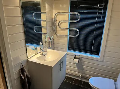 a bathroom with a sink and a mirror at Cozy family cabin at Hovden in Bykle