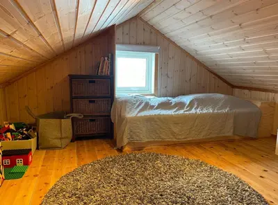 a bedroom with a bed in a attic at Cozy family cabin at Hovden in Bykle