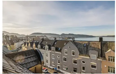 a view of the roofs of buildings in a city at Bergenhus apartment in historical Sandviken in Bergen