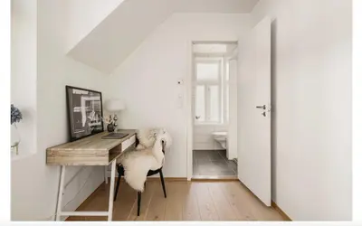 a home office with a desk and a chair at Bergenhus apartment in historical Sandviken in Bergen