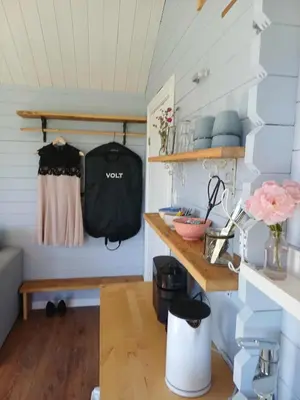 a room with a bench and shelves in a room at Lovely tiny house with a dream view !