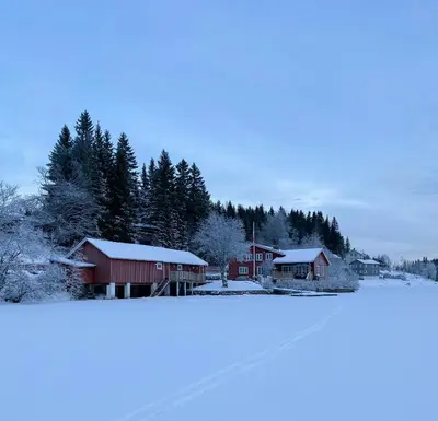 a group of houses with snow on them at Family Cabin By Lake Mylla With Private Dock in Lunner