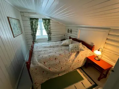 a bedroom with a bed in a small room at Family Cabin By Lake Mylla With Private Dock in Lunner