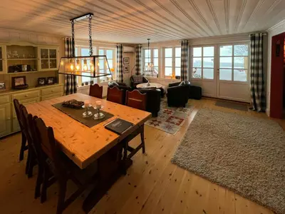 a living room with a wooden table and a couch at Family Cabin By Lake Mylla With Private Dock in Lunner