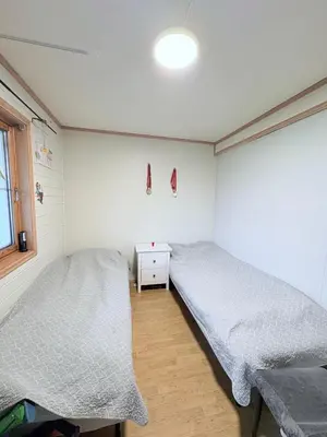 a bedroom with two beds and a window at Sentral og romslig leilighet på Levanger in Levanger